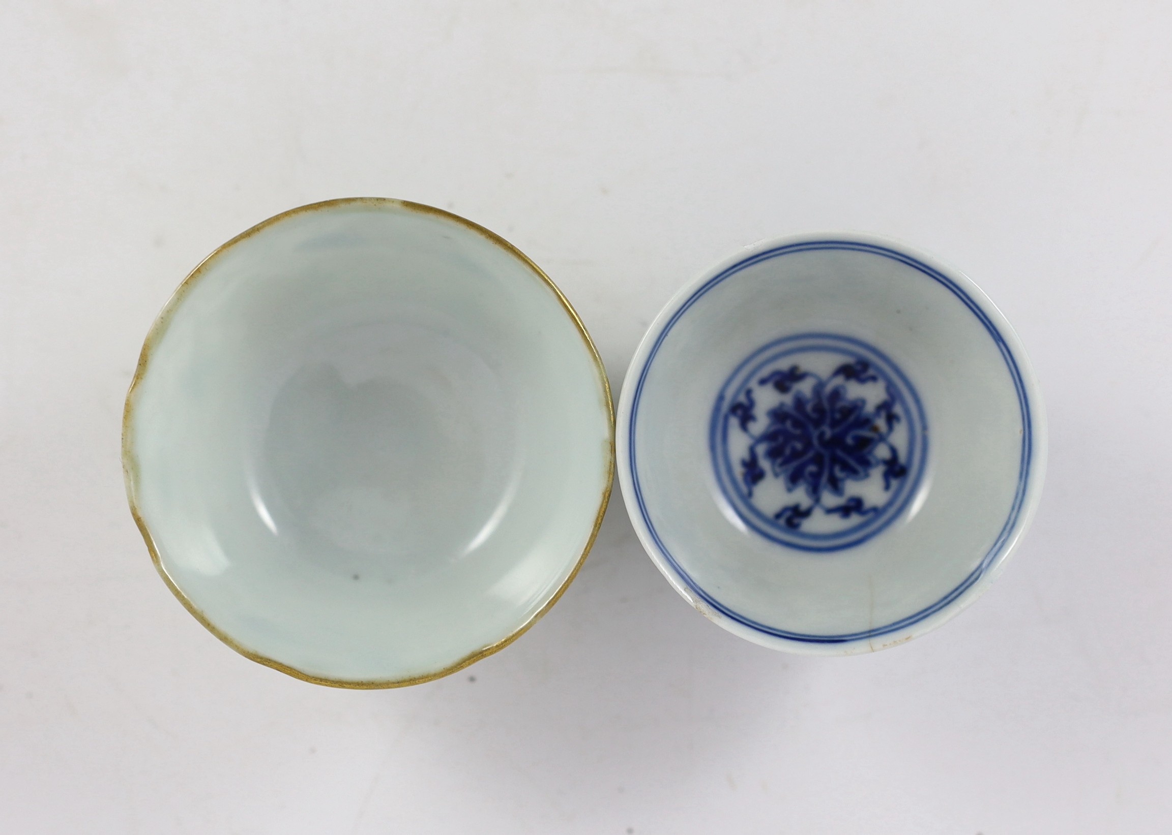 A Chinese enamelled porcelain ‘butterfly and melon’ cup, Republic period and a Chinese blue and white ‘lotus’ cup, late 19th century, (2)
